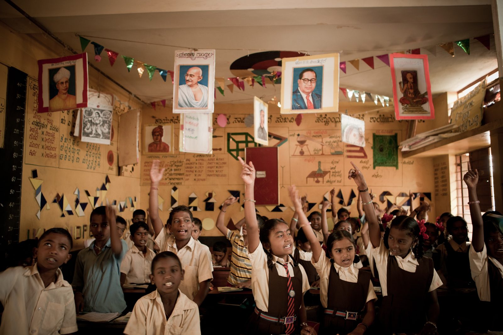 Students raising hands in class